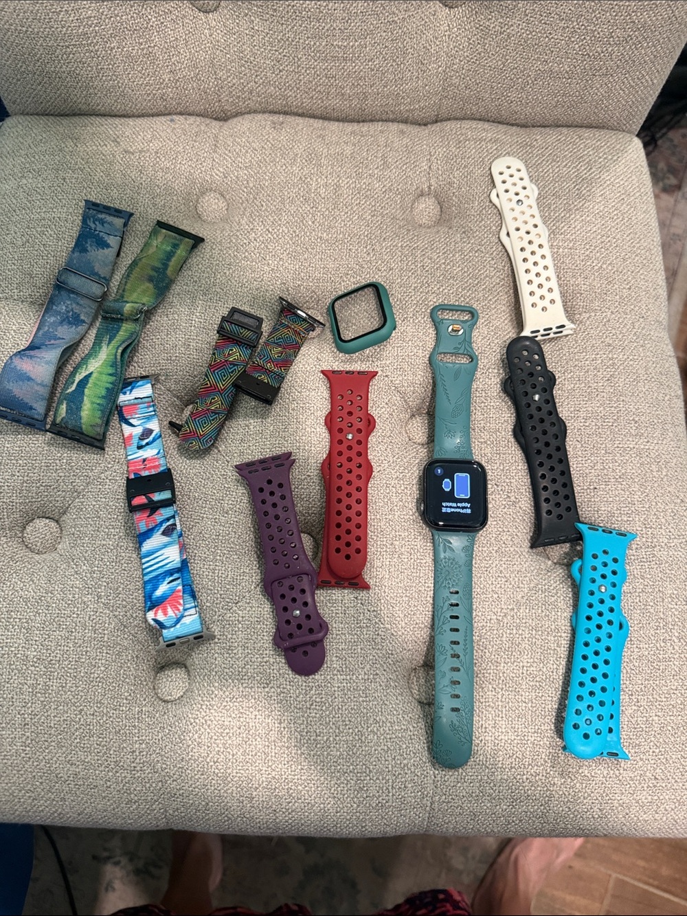 Apple Watch SE with several watch bands and an extra protective case.